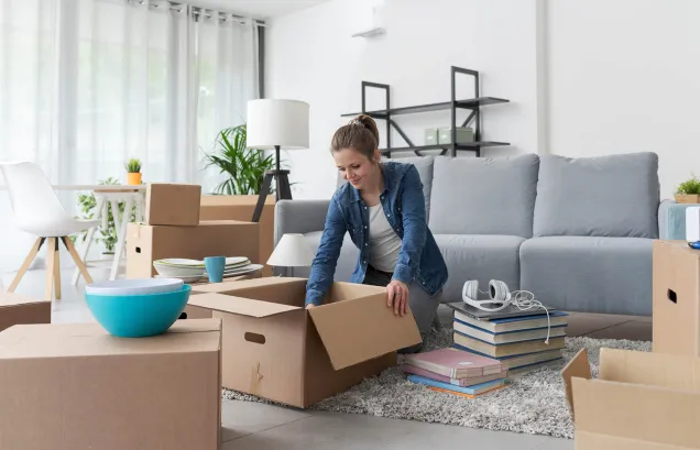 woman moving in unpacking boxes