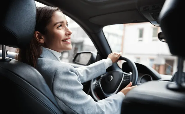 woman smiles up in a car