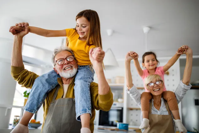 grandparents with girls on their shoulders